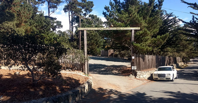 Street view of the main gate to the Outdoor Forest Theater Park on Mountain View Ave. and Santa Rita St. in Carmel by the Sea, CA
